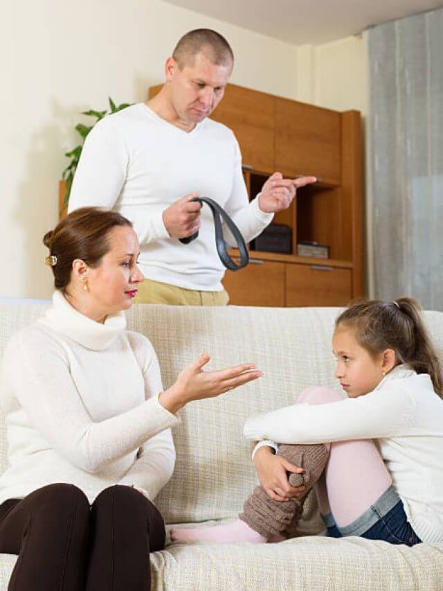 Angry parents berating daughter in living room at home
