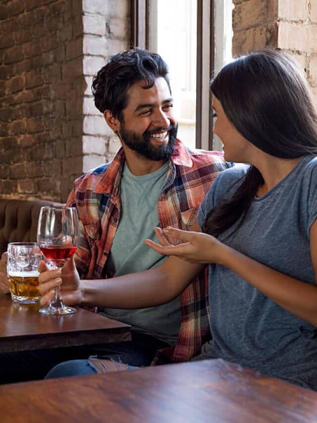 Happy couple sitting in bar on a date.
