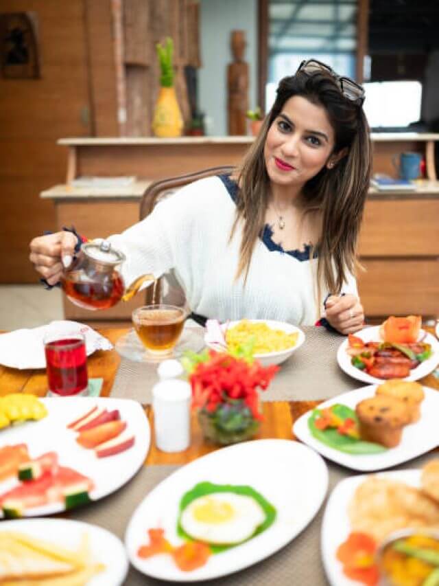 Young women drinking tea and eating morning breakfast