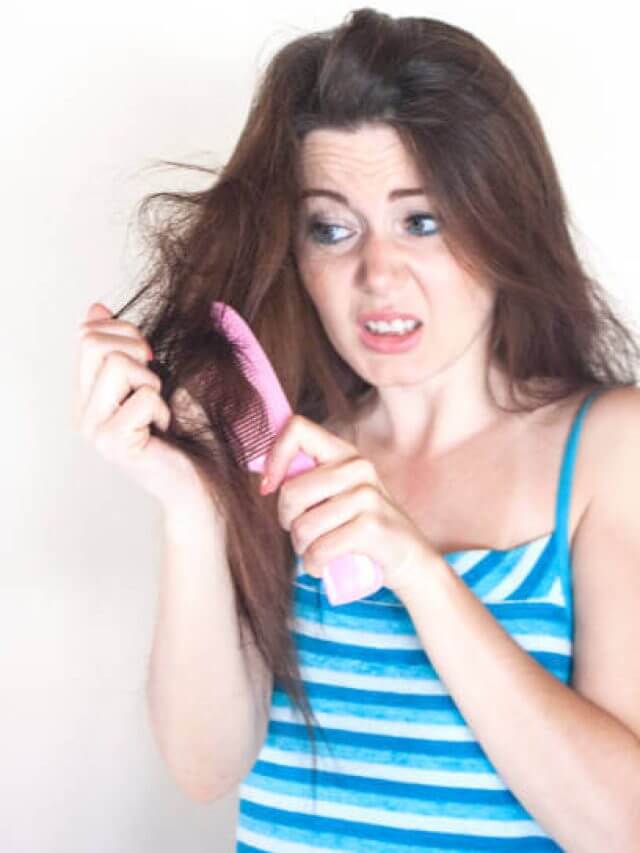 Girl combed her tangled hair hardly on white background