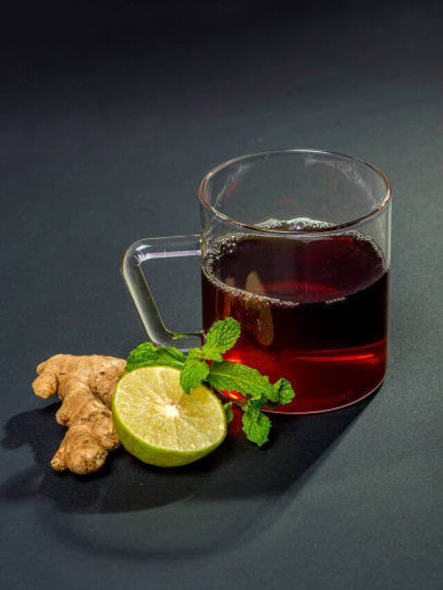 Cup of tea, mint and lemon on dark background