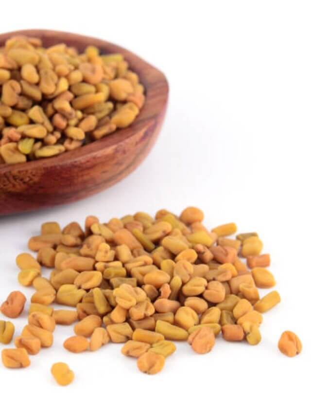 Fenugreek seeds in wooden spoon isolated on white background