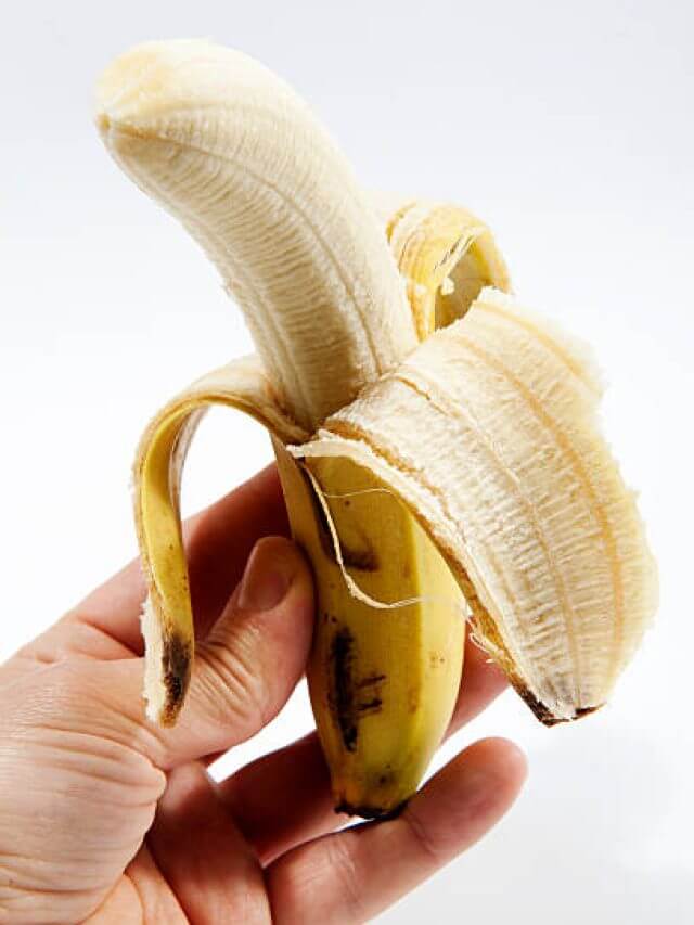 hand holding peeled banana