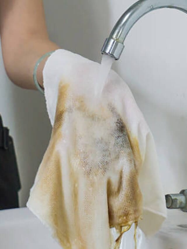 Female hand cleaning dirty rag
