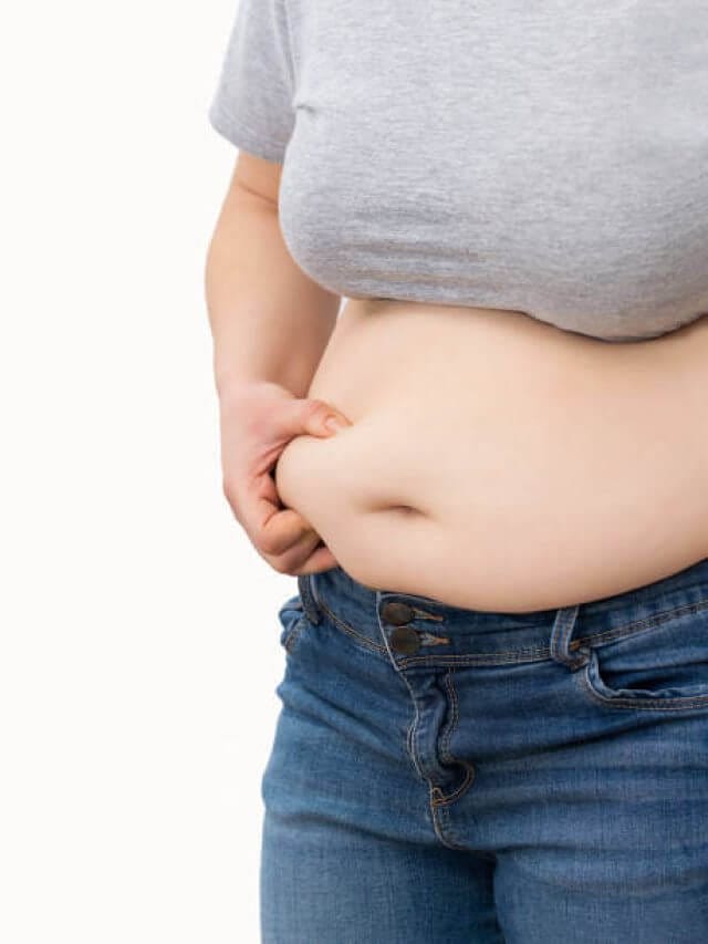 Close up of a obese young woman checking her fats