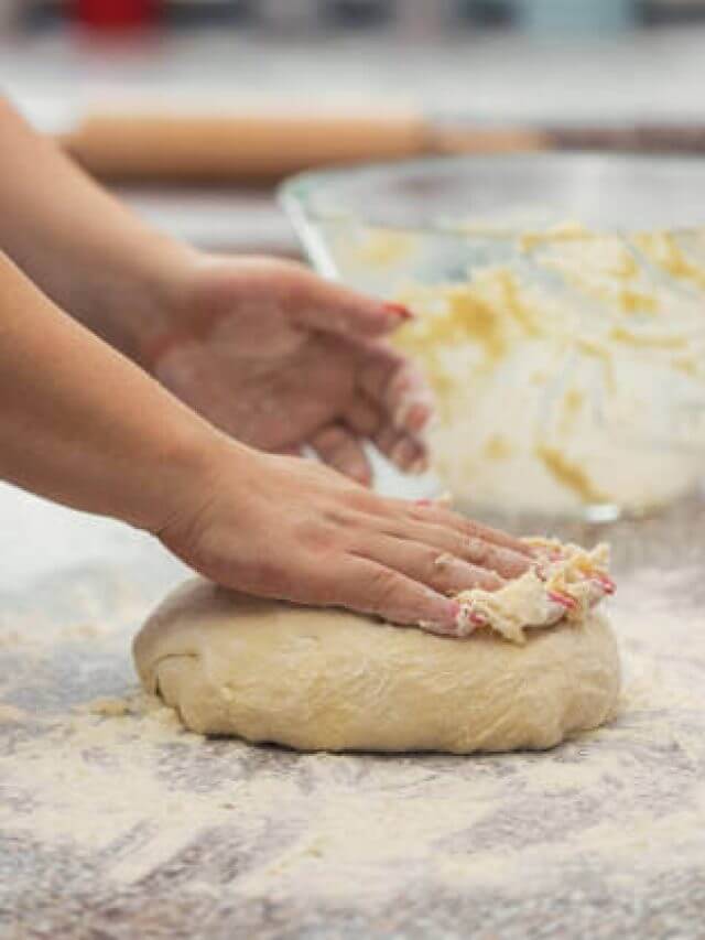 A woman kneading dough for fresh homemeade donuts