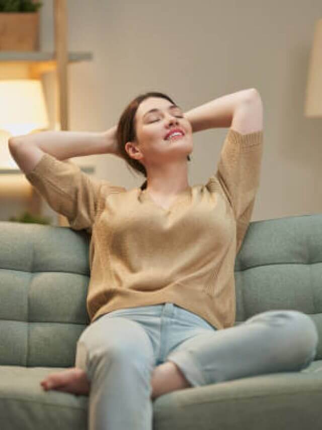 Portrait of beautiful woman resting on sofa at home