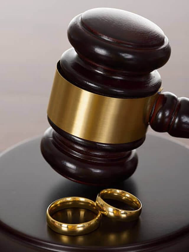 Close-up Of Wedding Rings And Wooden Gavel