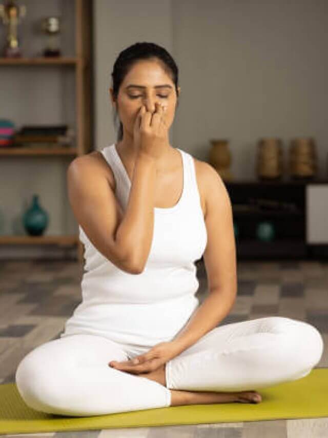 Young woman meditating at home