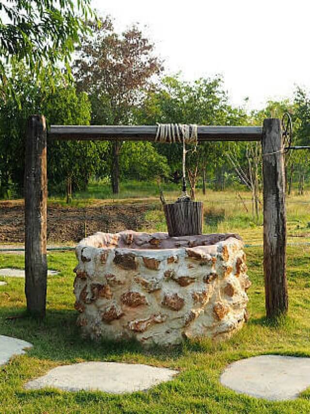 Old countryside water well With Pulley and Bucket.